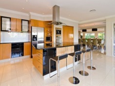 This prestigious estate is situated at the end of the highly respected Maryland Avenue. Situated in privacy behind grand electric gates and sand stone walls are two prime acres on two titles.

The architect has designed this home to maximize its North facing position with views to the East as well. This park like setting with mature trees is elevated 1.7 meters above adjoining land and has not been affected by major floods. This recently refurbished residence offers 1,000 square meters of opulent decor with the latest sinks, tubs and tap ware. Separate from the main house and situated near the entry gates is 2 bedroom guest house with its own complete kitchen, laundry, lounge and study. A large pontoon and wharf beside the river gives access to the Broadwater and out to the ocean from your back yard.

Features of this property:

7 Bedrooms, 6 bathrooms, 5 car garage with parking for upto 10 vehicles
Master bedroom includes parents retreat, twin dressing room, riverside balcony, and deluxe ensuite
Designer chefs kitchen with granite bench tops, 2 oven plus warming ovens, and walk in pantry
A Helipad has been approved for this estate.
Championship tennis court with flood lights and pavilion with kitchen, bath and shower.
10 meter pontoon, jet ski cradle, power and water supply
Infar-red security cameras with back to base alarms
Automatic emergency power generator
fully automated irrigation
Future sub- division potential - subject to council approval
Formal living area with open fireplace
Wine cellar
indoor/outdoor entertaining
In-ground swimming pool
in home theatre with elevated seating and soundproof walls
Games room
sizable laundry
Ducted air-conditioning
Landscaped gardens with mature trees and lush lawns, Horses are permitted on the property
Sweeping 200 degree river and skyline views
Less than 5 minutes drive to Royal Pines Golf Resort, Emerald lakes golf, Lakelands golf
8 min drive to Major Shopping Centres, Schools and Central Business district
This property is currently on two titles with an option to purchase the main house and guest house on 1 acre, or purchase 1 acre of riverfront land for offers over $2 million