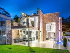 Tailored for luxury living, this cutting edge, sub-station style residence delivers a flawless combination of style and comfort on an 810m2 allotment. Expertly designed and built by Tustin Constructions, this home is lavish and sophisticated, yet thoroughly effortless throughout all 5 levels and easily outshines its peers in presence and position.

A seriously stylish industrial interior opens up to a spectacular open plan layout to reveal dramatic design elements incorporating high specification finishes including honed concrete floors with heating, polished white set concrete walls, remarkable clay bricks sourced from period buildings in Sydney and age from 80 to 90 years old, 2 automatic Monarch vertical stacking bi-fold doors creating a seamless flow between inside and out.

A gourmet kitchen incorporates a striking combination of stainless steel bench tops, dramatic black cabinetry and is complemented by an array of quality appliances and walk-in pantry. The kitchen flows out to the poolside terrace, complete with built-in BBQ making this area superb for entertaining guests. The 2m deep pool has provisions for solar heating if desired. Why not step it up a notch and guide your guests up the spiral staircase to the roof top deck, where an absolutely mind-blowing 360?? view awaits that will undoubtedly impress.

The second level finds the presidential master retreat, which is immense in size and unreservedly opulent. Boasting a custom-built walk-in robe and a glamorous ensuite that offers a relaxed ambience and is complete with heated flooring. Additional bedrooms on this level both offer built-ins, air-conditioning and ceiling fans, and share a designer bathroom also with heated floors and separate bathtub.

The lower level affords versatility for family and guests alike by providing a hotel style suite, making this room a perfect teen retreat or perhaps cater for an Au pair. An additional room within the garage could quite possibly be a textbook man cave, however, as it is complete with an ensuite it gives you the option to use as a fifth bedroom if desired.

This immaculate home focuses on quality and comfort with no expense spared. Comprehensively appointed with extras including Synergy glass windows and doors, Grey Iron Bark floors, 6 car garage, additional 2 undercover car spaces and prestige fittings and fixtures throughout.

Crafted with exceptional vision and passion, this property is nothing short of breathtaking!