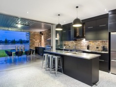Tailored for luxury living, this cutting edge, sub-station style residence delivers a flawless combination of style and comfort on an 810m2 allotment. Expertly designed and built by Tustin Constructions, this home is lavish and sophisticated, yet thoroughly effortless throughout all 5 levels and easily outshines its peers in presence and position.

A seriously stylish industrial interior opens up to a spectacular open plan layout to reveal dramatic design elements incorporating high specification finishes including honed concrete floors with heating, polished white set concrete walls, remarkable clay bricks sourced from period buildings in Sydney and age from 80 to 90 years old, 2 automatic Monarch vertical stacking bi-fold doors creating a seamless flow between inside and out.

A gourmet kitchen incorporates a striking combination of stainless steel bench tops, dramatic black cabinetry and is complemented by an array of quality appliances and walk-in pantry. The kitchen flows out to the poolside terrace, complete with built-in BBQ making this area superb for entertaining guests. The 2m deep pool has provisions for solar heating if desired. Why not step it up a notch and guide your guests up the spiral staircase to the roof top deck, where an absolutely mind-blowing 360?? view awaits that will undoubtedly impress.

The second level finds the presidential master retreat, which is immense in size and unreservedly opulent. Boasting a custom-built walk-in robe and a glamorous ensuite that offers a relaxed ambience and is complete with heated flooring. Additional bedrooms on this level both offer built-ins, air-conditioning and ceiling fans, and share a designer bathroom also with heated floors and separate bathtub.

The lower level affords versatility for family and guests alike by providing a hotel style suite, making this room a perfect teen retreat or perhaps cater for an Au pair. An additional room within the garage could quite possibly be a textbook man cave, however, as it is complete with an ensuite it gives you the option to use as a fifth bedroom if desired.

This immaculate home focuses on quality and comfort with no expense spared. Comprehensively appointed with extras including Synergy glass windows and doors, Grey Iron Bark floors, 6 car garage, additional 2 undercover car spaces and prestige fittings and fixtures throughout.

Crafted with exceptional vision and passion, this property is nothing short of breathtaking!
