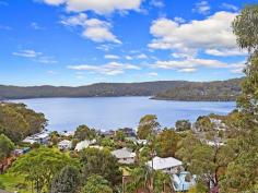 29 Albert Street, Wagstaffe NSW  Set high amongst native bushland, backing onto the Bouddi National Park with breathtaking, north-east facing water views, is this nature lover's retreat. Your stunning views can never be built out from the elevated position that this home provides. Enjoy the sunny north-east aspect from the expansive front deck, with views over the water ways from Killcare to Booker Bay & beyond. Timber floorboards throughout create a natural, rustic charm and the open plan kitchen / living area is flooded with natural light through large windows and sliding doors to the deck. The main bedroom has a walk-in robe, private back balcony and access to the main deck at the front. Downstairs, a large self-contained area provides a 4th bedroom or perfect guest accommodation / home office with separate access. A PJ King inclinator transports you to the upper level and all just a five minute walk to the Wagstaffe store, community hall and the Palm Beach ferry wharf. 