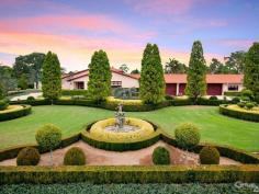 Dural NSWStory Of A Fairy Tale A beautiful blend of timeless charm and modern styling is this magnificent double bricked home set on 1.43 (approx.) desirable landscaped hectares. Every direction you turn there is something amazing to see from water features to amazing gardens to the detail of the architectural design of the home.  Upon entering the driveway through the wrought iron electric gates you will immediately feel as though you have stepped into a fairy tale! You will love the impressive grand entrance with marble floors, huge crystal chandeliers and sublimely crafted centre piece. The style and features of this property cannot be expressed purely in words. However, here is a taste of what this magnificent estate comprises of:  * Elegant formal lounge room with fireplace expanding to the sunken formal dining room  * Gourmet timber kitchen equipped with Miele appliances, granite bench-tops, dishwasher, 3 ovens, microwave and an island bench with a selection of cooking elements  * Huge walk-in pantry leading to the cool room  * Meals area off kitchen  * Family room with fireplace  * Casino dubbed room off family room  * Ballroom with bar, stage, commercial grade kitchen fit for a chef plus a billiard room - Perfect to host your own Great Gatsby party!  * Additional lounge room with pitched wooden panel ceiling, sink and French doors opening to the yard  * Master bedroom with walk-in robe, ensuite and it's own courtyard  * Ensuite to the other 4 bedrooms in the main house  * Resort style bathroom with spa, dual sink, shower and toilet room  * Guest wash closets  * Cancel your gym membership as it includes a gymnasium room and sauna  * Extra living room with laundry tub to the right wing  * The guest house features a lounge & dining room, kitchen with dishwasher, 2 bedrooms and bathroom with separate toilet  * 2 entertainment areas overlooking the pool and BBQ area  * Alluring salt water inground pool with spa, waterfall and it's own island surrounded by palm trees and plants  * Hold your own grand slam with this full size tennis court  * Lots of grass area - perfect for playing croquet or equestrian  * 22x12m shed/mechanic workshop with stable  * 6-car automatic garage  Additional features include: imported Italian wallpaper, ducted air conditioning throughout, alarm system, intercom, security camera system, detailed cornices, high ceilings, feature skylights, French doors & windows, huge laundry, study room, 35,000L underground water tank, septic tank, timers to the external lights and fountains.  Turn your dream into a reality!  For a full list of inclusions and to arrange a private inspection, call Ruma Mundi today on 0411 030 202 or 02 8883 1088. 