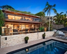 ‘Villa Gabrielle’ graces an address reserved for a privileged few with three architect designed levels embracing sweeping ocean views to Mount Warning. This property has a series of customised living and entertaining spaces and is footsteps to the beach.
Glass doors open to reveal the best views in Byron Bay
Double height foyer has an aquarium and Italian marble floor
Split level dining area and Miele equipped designer kitchen
Lounge features blackbutt floors with a red mahogany border
Tropical gardens reveal a stone water cascade and log gazebo
Black tiled 12m swimming pool with a Japanese stone wall
Double bedrooms pair with deluxe, bespoke feature bathrooms
Master enjoys a level of luxury and a sea view bath ensuite
Vast 734sqm block with lane access and stairs to beach
Near conservation area and minutes to the heart of Byron Bay