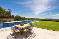 54 Lane Cove Road,  Ingleside NSW For Sale - Offers Over $8,500,000  8  9  6 Unequivocally one of Sydney's finest estates, this magnificent 5 acre holding has left nothing undone its quest for luxurious liveability. From its spectacular gala indoor/outdoor entertaining venues including a tennis court, 26 metre heated pool, indoor jumps arena and state-of-the-art stables, it exceeds the expectations of the most discerning elitist on every front. Nestled on private rolling lawns with sweeping 180 degree north easterly ocean and coastal vistas, it is only 30 minutes from the CBD and moments to village shops, schools and beaches. Drive through the secure gated entry and wind your way past the timber post, rail paddocks and cascading waterfall to the residence. From the moment you lay eyes on the exquisitely crafted facade it becomes immediately apparent that this residence is of the highest calibre. Exquisitely crafted from sandstone and wrapped in a timber posted bull-nose verandah with a large turret romancing the facade, it tastefully fuses Australian colonial and European provincial themes with designer finishes to create a retreat of elegance and sophistication with a warm country-style ambiance. Guests are welcomed through the grand formal entrance foyer with soaring double height ceilings with an elaborate antique chandelier lighting the way. The living spaces have been cleverly interwoven to integrate with an enormous indoor/outdoor loggia with an open fireplace. Separate living and dining areas merges seamlessly with level lawns and soaks in the north easterly sun, summer breezes and sweeping views. It comes complete with formal living and dining spaces plus an enormous family room or home cinema with surround sound and mounted flat screen TV.  Finished in imported Italian marble with a breakfast bar and state-of-the-art European appliances, the kitchen is equipped with a commercial-grade gas stove with barbecue plate and two ovens, two integrated dishwashers and pantry. King sized bedrooms all with built-ins and ensuites. The palatial master forms the heart of circular turret & features towering ceilings, dressing room, wardrobes built into the circular wall & a spiral staircase that leads to a circular mezzanine library with access to the sun drenched terrace with spectacular views.  Absolute heaven for the dedicated wine connoisseur, the wine cellar is locked behind iron gates and consists of a labyrinth of sandstone walled rooms with cedar wine racks holding up to 4,000 bottles. 