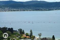 EXECUTIVE/FAMILY HOME WITH PANORAMIC HARBOUR VIEWS FOR SALE - $795,000+ It is indeed a treat to live in Hobart and be able to enjoy one of the most amazing views in the world. Every room in this executive home enjoys a spectacular outlook, which encompasses the City, Casino, harbour, iconic Tasman Bridge and Eastern Shore as far as Bruny Island. This really is something special. The sun streams through the windows making the home light, bright and (most importantly), warm. The benefit of the Northerly aspect is maximized with a deck (with automated "Vergola") extending from the main living room and master bedroom, together with a balcony extending along the front with sliding glass doors from the informal family room. The hub of most homes is usually the kitchen and here, there's a sparkling white kitchen with black granite benches for the family chef to enjoy. With plenty of storage and preparation space, and having informal meals and family areas adjoining, you'll always feel involved with family and friends as you prepare the next culinary delight. Ideal for a family, this home offers 5 bedroom accommodation. The master bedroom enjoys a walk-in robe and ensuite, together with access through glass doors to a deck. It would be hard to think of a day where you wouldn't wake up feeling on top of the world, when you have the panoramic views offered here to wake up to! With both formal and informal rooms together with decks for entertaining, one would think that everything had been taken care of, but wait, there's more! An indoor natural-gas heated pool and gymnasium offer year-round fun and fitness opportunities for your family and, if you feel like relaxing in front of a great movie, the media room is just the place for you to snuggle up with pop corn or an ice cream and escape for a while.  Built with ease of living and comfort in mind, other features of this home ducted reverse-cycle air conditioning, ducted vacuum system and intercom system throughout, together with underfloor heating in the main bathroom downstairs (together with 1 bedroom) and throughout the entire first floor. Outdoors is a small, low maintenance garden with a range of fruit trees and some beds awaiting you to grow your own vegetables. In close proximity of schools, UTas, shops and services and just 6-8 minutes from the city, this is an executive home of generous proportions and enjoying a spectacular harbour vista. We'd be delighted to show you through on a personal inspection, so please call Michael or Jill to schedule a suitable time. PROPERTY OVERVIEWProperty ID:3P1612Property Type:HouseLand Size:559m² approx.Building Size:341m²Garage:2Car Space:2Inspection Times:As Advertised or by Appointment 