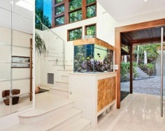 ‘Villa Gabrielle’ graces an address reserved for a privileged few with three architect designed levels embracing sweeping ocean views to Mount Warning. This property has a series of customised living and entertaining spaces and is footsteps to the beach.
Glass doors open to reveal the best views in Byron Bay
Double height foyer has an aquarium and Italian marble floor
Split level dining area and Miele equipped designer kitchen
Lounge features blackbutt floors with a red mahogany border
Tropical gardens reveal a stone water cascade and log gazebo
Black tiled 12m swimming pool with a Japanese stone wall
Double bedrooms pair with deluxe, bespoke feature bathrooms
Master enjoys a level of luxury and a sea view bath ensuite
Vast 734sqm block with lane access and stairs to beach
Near conservation area and minutes to the heart of Byron Bay