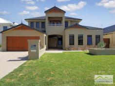  6 Lautoka Rise, Mindarie WA Beaumonde homes have been built on reputation since 1986 and this stunning 2008 built home is a classic example of the style, quality of craftsmanship and attention to detail that Beaumonde demand.  The owners of this gorgeous home insisted on important facets of the build to ensure their home exuded sophistication and quality like 38 and 37 course ceilings, imported Italian porcelain tiles, pewter granite, Eastern Blackbutt flooring from Grandwood floors and Daiken Reverse Cycle Ducted Air conditioning.  Not only is this home a stunning/quality built property but it is located in a very desirable position only minutes walk to the Mindarie Marina, Claytons beach the schools and shops. Gorgeous ocean views greet you as soon as you walk upstairs with the bright blue sparkle of the pool below.  This home is faultless, see the list of features below:  Level One:  Inviting generous decked porch area with double door entry  Classic beautiful lobby bringing you into the formal lounge  Formal Lounge the perfect place to great your guests  Double Doors lead to the open Family/Dining/Kitchen-the most important and most used area of the home with recess area to family room for the TV, a bank of glass surrounding the dining area.  Huge kitchen with Pewter granite bench tops that have shark nosed edging, massive walk in pantry, central island work area giving you uninterrupted views of the swimming pool, quality under bench oven and gas hot plate with overhead stainless steel and glass range hood. Appliance cupboard and good sized fridge recess plus plenty of preparation area  Leading from the hub of the home you enter the purpose built Theatre Room with dual access to the outdoors so can be a multi-purpose room great as a big play room when the children are small  Three very generous children?s bedrooms all with double robes and of course those 38 course ceilings  Main Bathroom has a separate WC with powder room which then leads to the main shower and the oval bath  Walk in Linen giving plenty of storage  Well equipped laundry Level Two:  Beautiful elegant staircase leading to the top level  Huge open space consisting of the Study and the upstairs Lounge  Kitchenette/Bar upstairs with glass splashback, fridge, microwave and sink  Massive balcony with beautiful ocean views  Main Bedroom Suite with private balcony thru double doors  Massive walk in robe  Amazing En suite with double basin vanity, huge oval spa bath, generous shower and separate WC Extras you will enjoy:  Outdoor Cabana with decking and timber lined ceiling that overlooks the pool  Stand Alone bricked Shed ? ideal to convert into shower block  Ducted Reverse Cycle Air conditioning  Solid timber flooring and Italian porcelain tiling  Warm timber double front doors  Storage under the Stairs  Huge double garage with sectional remote door  Quality light fittings and down lights  Wrap around below ground swimming pool with water feature  Extensive limestone paving surrounding the home  Grassed area for the kids to play  Side access thru timber gates  Completed in 2008  Approximate size of home in total 380sqm  Block size 612sqm 