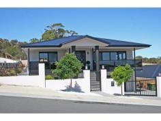 70 Oakdowns Parade, Oakdowns TAS This impressive near new home exudes quality inside and out. Cleverly designed with the growing family in mind there is space galore for everyone! The vast expansive living, dining and kitchen areas feature a beautifully tiled floor and large double glazed windows capturing the vista. An entertainer?s kitchen has it all ? quality appliances with dual gas and electric cooking; island bench and granite bench tops; soft close drawers; walk in pantry; dishwasher and ?plumbed in? stainless steel refrigerator with water dispenser. There are four bedrooms all with built-ins (two on the upper level and two on the lower level). The master bedroom includes a walk-in robe; an ensuite bathroom with spa; and a private balcony overlooking the rear yard. Three designer bathrooms feature floor to ceiling tiles. An internal staircase services each level. A huge lower level area is ripe for development (STCA) and would make an ideal teenager retreat or rumpus with extra bedroom. The separate laundry has a handy clothing chute from the master bedroom above! A remote controlled double garage has internal access. Outside there are level landscaped grounds and substantial concrete verandahs and deck areas around the home. Quality rendered retaining walls provide security and integration with the house design. Other features include: built-in surround sound system in upper living area; two heat pumps; camera surveillance security system; remote control entrance gate; LED lighting throughout; and extra storage under the stairs. The panoramic views from Ralphs Bay to Mt Wellington provide the perfect backdrop to this stunning home! * If you are looking to purchase around this range we recommend an inspection. This is not the selling price but a Buyer Inquiry Range. 