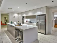 Distinctive Executive Design offering enviable lifestyle
Designed by Brisbane renowned architects Arkhefield, the residence rises from the street to a commanding position on 810m2 - a statement in engineered executive architecture and design. The angular vertical and horizontal planes, innovative utilization of glass sliders and bi-folds has created a residence that flows seamlessly inside to outside and from formal to informal living. Spanning three levels the home captures views overlooking Bardon to Brisbane city, as well as the gentle north-easterly breezes. Distinctive and unique, it is a residence that accommodates the growing family to perfection.

Entry
* Formal living and dining is elevated on a spotted gum timber floor and spills out onto the covered verandah perfect for entertaining
* Gourmet Galley style kitchen featuring Corian bench tops, sleek cabinetry and stainless steel appliances
* Open plan family living and dining flows out to a private patio 
* Three generous bedrooms, with built-in robes and ceiling fans
* Study that shares the patio
* Fitted laundry 
* Family bathroom and Powder room

Ascending the central suspended staircase
* Parents retreat with stylish ensuite featuring spa bath and twin basins
* Generous walk-in wardrobe
* Glorious views to the city and surrounds

Descending the central suspended staircase from the entry level
* Glorious undercover alfresco living overlooks the infinity edge in-ground pool and beyond
* Media /Rumpus room 
* 3rd bathroom
* Triple lock-up garage with generous storage space

Outstanding features
* Architectural innovation and style
* Combination of spotted timber floors, tiles and carpeted bedrooms
* Ceiling fans in bedrooms and ducted air-conditioning throughout
* Stylish attention to detail and finish

Positioned in a tightly held pocket amongst prestigious residences this home offers an enviable lifestyle that supports your executive needs. Located close to schools, parks and local shops with the Paddington and Rosalie cafe precinct, and City are on your doorstep.

For more information please call Andrew Degn 