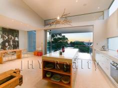 18A Elsegood Avenue, Yallingup WA Exclusive Holiday Escape This architecturally designed 4 bedroom, 4 bathroom residence on Yallingup hill sets the bench mark in holiday living. Designed by multi award winning architects JCY and built by Ridgeway Constructions, it is the blend of contemporary style, quality appointments and luxurious touches that make this property truly special. As you walk through the front door an array of wide staircases and hallways lead you to the many secluded wings presented in this tri level house. Numerous bi-fold doors and generous use of glass ensures there is a seamless blend of indoor and outdoor living spaces. The upper level is an expansive space enhanced by the high ceilings and flooded with natural light from glass bi-fold doors and windows positioned to capture light while maintaining privacy. The open plan living/dining/kitchen area boasts high-tech and modern conveniences that create an environment of effortless luxury including heated Travertine flooring, to a full C-Bus down lighting and data connection at your fingertips and a Bose surround system for your favourite holiday tunes. Creating your favourite gourmet delights will be a breeze in the spacious deluxe kitchen. Featuring the latest appointments with beautiful white stone bench tops including huge island bench, soft closing drawers, an abundance of storage space and top of the range Miele appliances including 2 stainless steel ovens, separate steam oven, microwave/grill, dishwasher, cook top and range hood.  Open the bi-fold doors and you seamlessly expand this area to include the large balcony with outdoor kitchen, plunge pool and is the perfect place to enjoy colourful sunset skylines. From dinner parties to a long lunch in the summertime this is the ultimate entertainment space for every occasion. The 4 bedrooms are spread across 2 levels. Each is a private retreat reminiscent of a 5 star resort with its own private ensuite. Downstairs the 2 enormous master suites include his and her vanities with stone bench tops and deep spa baths and double showers that open out onto private decks. Upstairs 2 large minor bedrooms offer high ceilings, reverse cycle air-conditioning and ensuite with vanity and shower. The minor bedrooms extend from the second living area which makes this level the perfect kids retreat. The second living area also features surround sound, down lighting and built in desk for office space. The lower level has a beautiful separate powder room and a laundry with ample storage space. The luxury extends outside the home where thoughtful features ensure the atmosphere of fun, rest and relaxation is continued including low maintenance landscaped garden, a private reticulated garden courtyard that makes the perfect yoga pavilion, bocce court and at the front of the home the outdoor shower with feature wall is a wonderful way to refresh when you have returned from the beach. An exposed aggregate driveway leads to a double carport which also houses two separate keypad coded storage rooms that can be accessed externally. One is set up as a cleaner’s room and allows for linen deliveries and the other houses the electrical equipment for maintenance access. No detail has been forgotten when creating this ultimate holiday residence. In excess of $250,000 in C-Bus lighting, data connection and security features throughout the house ensures you can program everything for your arrival and departure. Hotels will be a thing of the past when you have your very own holiday retreat located within close proximity to famous Yallingup beach, world class surf breaks and in the heart of the South West with its many wineries, tourist attractions and natural wonders. Inspection is a must. Call today! 