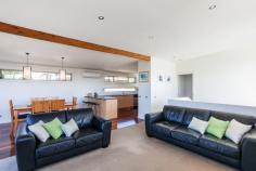 2 Eastview Terrace, Jan Juc VIC Enjoy the Eastview Lifestyle! If you are seeking out a home in Jan Juc it stands to reason that you are drawn to the water, what better way to fulfill that need than with a view of the ocean to wake up to every morning. Situated in one of the quieter pockets of a relaxed coastal village, this property in Eastview Terrace takes full advantage of its position which is in easy walking distance to the beach, golf club and shops ensuring you enjoy the landscape and local lifestyle. Contemporary in design, the double story home makes the most of an easy care block of land by maximising both living and outdoor space. Inside, four generous bedrooms on the ground floor are serviced by both a modern family bathroom and ensuite to the master with all except the fourth bedroom enjoying the benefit of WIRs. Providing direct access to the gardens (complete with large garage, double carport and secure parking for boat/caravan), a large second living area on this level provides flexibility and a perfect retreat for the younger members of the family. The upper level is dedicated to everyday living with a bright, spacious kitchen flowing through the dining and family rooms (beyond the handy powder room) onto a well_positioned balcony that offers sweeping, panoramic views over the ocean. Clever design elements, such as the north facing highlight windows, flood the room with natural light giving further depth to the richness of polished timber floorboards whilst, the morning sun through the expanse of windows opening to the balcony invite lazy breakfasts with a paper and the reminder that you do indeed, live by the beach. The simplicity of good quality, well maintained fixtures and neutral tones makes this a comfortable, functional and laid_back home to live in. It is a welcoming home that offers families an opportunity to live their coastal dream without fuss but with a real emphasis on capturing the desire and making it real! 