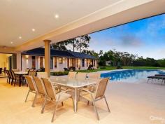 Glenhaven NSWResort Style Living on Acreage A masterpiece of contemporary design is this luxurious property set on 6 acres (approx.) in one of Hills Districts' sought after prime position. The stunning architecture of this home blends beautifully with the natural bushland setting. With approximately 5 arable acres, this home offers the best of both worlds, perfect sanctuary away from the hustle & bustle whilst having the convenience of being within a short drive from Castle Towers Shopping Centre, local schools, medical centres and transport.  Featuring high ceilings throughout and a light filled floor plan you'll enjoy the pool and garden views from every corner of this spectacular home. With everything a family can wish for and more, you will be spoilt for choice!  * Gorgeous driveway with automatic gates leading to the front porch overlooking the koi pond  * Impressive entrance through the double doors leading to the formal and informal areas  * Stunning high quality kitchen with stone bench tops, large walk-in pantry, dishwasher, built-in double oven plus coffee machine, water filter and more  * Casual dining and living areas off kitchen overlooking the pool with bushland view  * Formal dining room opening onto private paved terrace  * Master bedroom suite with walk-in robe, additional cupboards and ensuite with his & hers vanity  * Additional 4 double sized bedrooms each with walk-in wardrobes and ensuite to 3  * Study room/home office fitted with built-in storage and wash closet  * Loft style staircase leading to the separate large attic - ideal for man cave or kids hideout  * Sprawling poolside alfresco and BBQ area with gas outlets  * Wet bar adjoining main entertaining areas  * Lavish sun-drenched 25m inground swimming pool and spa equipped with solar heating  * 2 underground water tanks  * Championship sized tennis court - Hold your own grand slam!  Additional lifestyle features include ducted air conditioning throughout, natural gas outlets, alarm system, video security system, polished hardwood floors, floor heating and four car garage with automatic doors. A rare opportunity to live an enviable lifestyle so close to all amenities yet giving you the space and privacy of acreage property!  The photos and description cannot replace the experience of a walk through inspection.  To arrange for a private viewing call Ruma Mundi on 02 8883 1088 or 0411 030 202. 