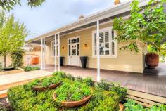 34 Princess Road, Claremont WA This award winning Claremont family home has been renovated and extended with impeccable style and sophistication, resulting in a stunning home that is brimming with character charm and contemporary luxury. The home's beautiful street scape has been admired by neighbours and passers by for many years. Featuring an intricate wrought iron fence, turned cast iron veranda posts, a wide wrap around timber veranda and a spectacular front door with coloured leadlight windows, the facade has made a lasting impression on many Claremont locals and lovers of character homes. Great care has been taken by the current owners to restore the circa 1898 home to its former glory. Undergoing a major renovation in 2010/11 under the guidance of highly respected architect Ben Croudace and the superb craftsmanship of Brooks Construction, the home was the recipient of two Town of Claremont Civic Design Awards in 2011 for the Conservation of a Timber Heritage Place and for Garden Conservation or Creation of a Sympathetic Period Garden. These awards are testament to the superb quality and presentation of the home. Accommodation includes 4 king size bedrooms (three with their own ensuites), 4 bathrooms, study, sitting/TV room and a kitchen, dining and family room. The original part of the home consists of a long, wide hallway, three king size bedrooms (two of which have their own ensuites) and a very spacious TV room which opens out onto the decked alfresco entertaining area.  A cleverly designed addition harmoniously links the original part of the home with a modern extension, which is filled with light and warmth. The extension encompasses an open plan dining, kitchen and family room, a family size bathroom, a laundry with French oak bench tops and extensive storage and a large undercover alfresco entertaining area. A separate parents wing is located on the second floor. The home has been designed for entertaining. The beautiful kitchen has long, twin benches; one in French oak and the other in grey Caesarstone. It features a free standing Ilve stove, double sink, white drawers and cabinetry, a double door pantry/appliance cupboard and a concealed computer nook. The dining space is large enough to accommodate a 10-12 seater table and has a concealed cupboard for wine storage. A family room with a gas fireplace is located on the far side of the kitchen and overlooks the sparkling 17.5m lap pool and spa. Commercial grade sliding doors connect the kitchen to an undercover, decked entertaining area which has an outdoor kitchen and separate zones for a dining table and outdoor lounges.  The parents wing is located on the second floor and features a separate study with built in bookshelves, a king size bedroom with a walk in robe, a lounge area with Juliette balcony and a huge ensuite bathroom with a double shower, double stone topped vanity and a separate toilet. The home is surrounded by lush, landscaped gardens filled with mature trees. A wall of ornamental pear trees borders the swimming pool, giving this space privacy and tranquility. The main living areas and bedrooms have lovely aspects over the gardens, giving the home a wonderful softness and serenity. Other highlights include: 809sqm green title block Alarm Ducted reverse cycle air-conditioning with two motors White timber plantation shutters Ceiling fans Shared bore Reticulated gardens 17.5m gas heated, self cleaning lap pool and spa Two solar hot water systems with gas booster Photovoltaic solar panels Gas fireplace in the family room Double carport Garden shed External storeroom 