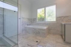  2 Albert Street, Claremont WA This low maintenance, two-storey home will appeal to buyers who are looking for a unique and stylish home in a convenient location. Awaiting your personal touch, this is a fantastic opportunity to add value to an already comfortable home. Located on an elevated block in the prestigious Claremont Hill locale, the renovated 1970s home is conveniently positioned within walking distance of the Claremont Quarter, Christ Church Grammar School and MLC, public transport and the river.  Set well back from the street, the home is accessed via a staircase which is secured by two striking black steel gates. Surprisingly quiet and private, the home is surrounded by terraced gardens filled with tall trees and shrubs, giving it a lovely tranquil ambiance. The level of separation is ideal for couples and small families. The master suite is located on the second floor of the home and features its own private balcony, marble clad ensuite bathroom and a dressing room. There is also a spacious sitting room. The kitchen features travertine flooring, timber cabinetry and a stunning waterfall edged stone bench top. The spacious dining room is large enough to host a formal dinner for 10 or a stand up party for many more. The kitchen and dining areas flow seamlessly into the front and rear outdoor spaces, creating a huge area for entertaining. Opening the sliding doors on the western and eastern sides allows the cool sea breeze to flow throughout the home, reducing the need for air conditioning in the warmer months. Two bedrooms with built in robes are located on the ground floor and share a marble clad bathroom which has been recently refurbished. A passageway leads to an open plan study and a welcoming sitting room with floor to ceiling windows, allowing sunlight to stream into this part of the home. These rooms overlook the paved alfresco entertaining area which is surrounded by tall walls softened by mature trees and vines.  An oversize double garage off a rear right of way provides secure parking. Other features include: * Split system airconditioning * Travertine floors * Raw silk curtains * Neutral colour palette 