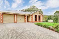 423B Main Road Coromandel Valley SA 5051 A modern, easy going lifestyle…deceptively spacious inside and out. Open by appointment during the week or first open Saturday 14th – time to be advised. Email your details to be kept informed! Built 2005, this 211sqm home enjoys an elevated aspect from its 823sqm allotment. With private access off the corner of Sandow Crescent/Main Road, you won’t realise your address is on the main road to Blackwood…the position is quite a surprise, and just at your front door there is a safe walk way to the shops and ‘Duck Inn’. 4 great size bedrooms – 2 bathrooms and 2 separate living areas. The main bedroom with walk-in robe and en-suite is quietly positioned in the middle of the home. There is a large 4th bedroom opposite that could be used as a home office/studio. The children’s or guest bedrooms and 3-way bathroom are ideally in their own wing – both have built-in robes. Complementing the main bedroom at the front of the home is a private lounge or theatre room. The combined open plan living space is perfect! A large kitchen with gas cooking, dishwasher and heaps of storage is featured with big bench-tops – the perfect spot to gather around without interfering with the chef! Beautiful rich timber floors are also a big feature of this space, contrasting so well with the soft neutral décor. There is plenty of space for your special dining table and family living. The whole home has ducted reverse-cycle air-conditioning throughout. The main living area is extended to the outdoors with a huge pergola that spans the width of the home. Quality pavers and sandstone block walls have created a beautiful garden feature that really makes this a fantastic spot to entertain all year round…lovely to look at from the indoors and it is very private! The only steps on this near level allotment are from the pergola up to a garden setting, extra yard space often missing in these types of modern homes. There is a lawn and paved area…you could build a hobby/garden shed and there is room for the veggy patch! There is easy access to a double garage under-main roof where there is a door to the side yard and secure internal entry. Conveniently, transport is nearby with a bus service to Blackwood train and Village shopping.