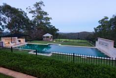 UPPER BROOKFIELD 654 Upper Brookfield Road Bed: 4 | Bath: 3 | Car: 3 | Tennis Court: 1 | Pool: 1 Grand Residence - Private Estate A sanctuary of privacy and nature on a mountain ridge at the southern end of the D’agular range, this magnificent family  home  lays claim to 10 acres of serene bush land in one of Brisbane’s finest boutique  “rural - residential” estates. Incredibly, the home itself is positioned on a flat, landscaped area of over one acre on the top of the mountain, facing North East. This mountain top location affords breathtaking, panoramic views over Brisbane, the  north and south  ranges and beyond to the islands of Moreton Bay. A true sense of arrival is experienced upon approaching the home via automated iron gates and a 250m long driveway, flanked by stonewalls and gardens. A cobblestone circular drive is bordered by manicured gardens and features a beautiful central  lily pond . The home reflects grandeur and elegance inspired by classical European style architecture. It offers absolute privacy, completely uninhibited by neighbours and the hustle and bustle of suburbia. Completed in 2007, the home is constructed of limestone blocks sourced from Mt Gambier, South Australia. Once inside, an impressive entry hall divides spacious his and hers studies. The hall guides guests to the focal point of the home; the “Grand Room”. Open plan in design, the light-filled Grand Room features soaring 14 foot ceilings, oversized windows and French doors and an attractive open  wood burning fireplace . It comprises of the formal lounge, dining and kitchen.  The kitchen is enormous and classical in its design. It features provincial style timber cabinetry, traditional butlers sink and stone bench tops. A striking iron chandelier hangs above the large island bench.  It showcases a comprehensive range of appliances including Ilve oven and gas cook top, integrated coffee machine, 4 dishwasher drawers, microwave and stainless  steel double door  fridge. Adjoining the kitchen is the media room, which includes surround sound and rear projector systems. The grand room opens via  sliding French doors  to an expansive covered entertaining terrace. It enjoys a perfect north east aspect and the most spectacular views of the grounds and beyond. The terrace offers direct access to the sparkling swimming pool. Approximately 16m x 4m, the pool area features Chelmstone paving. The resort style facilities continue with the property also boasting a championship north south tennis court with permaflex synthetic grass and lighting for night games. Ideal for entertaining, a gorgeous gazebo is located adjacent to the court. The main house has four bedrooms; each is generous in size and offers beautiful views of the surrounding bush land. Two of the family bedrooms share a cleverly designed two-way ensuite with separate vanities. The  master bedroom  is located in a private wing and enjoys a north aspect with views to the mountains.  It includes his and her walk in robes and an elegant ensuite with a classic freestanding bath, private shower recess and twin vanities with stone bench tops. A fourth bedroom is reserved as a guest room and is serviced by the family bathroom. There are also two outdoor showers. A laundry and mudroom complete the internal facilities. A large, 80m2 enclosed garage provides housing for 3 vehicles and abundant storage options. One of the most versatile features of the property is the fully self-contained 2 story guest house.  Constructed in 2001, it comprises 2 bedrooms and nursery (or large study) and a bathroom. The ground level offers a kitchen and a spacious open plan living and dining area which is currently used as a home gym and recreation room. There is also a large laundry/craft room and large workshop and storage area at the rear and covered parking for 2 more vehicles. The property is part of a gated rural residential estate, which offers a range of unique and exclusive facilities. These include common parklands with dam and two standard size golf greens. There is also a shared 40-acre equestrian reserve with a fully funded equestrian development plan for stables, arena and paddocks. In addition to the hiking and riding opportunities within the estate, the property backs on to thousands of acres of hiking and riding trails through the D’agular Range, Lake Manchester, Mt. Crosby and Mt. Glorious. Seldom does a unique and stunning residence claiming such significant land size, spectacular views and exclusive facilities become available in a private bush land setting this close to the CBD. This is a rare opportunity to secure a property of distinction, unparalleled privacy and an exclusive lifestyle. Features 4 Hectares (10 Acres) 1 Acre of Level, Landscaped Residential Area Elevated, North-East Aspect Panoramic Views over Brisbane, North & South Ranges & Moreton Bay Pool (approx. 16m x 4m) Championship, Floodlit North-South Tennis Court Gazebo Automatic Security Entry Gates Cobblestone Circular Drive 200,000L Drinking Water Tank (automatic pressure pump) 25,000L Irrigation Water Tank Automatic Irrigation System Established Herb & Veggie Gardens Orchard Area (currently unplanted) Chicken Coop Area 