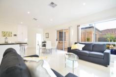 16 Laurence Street South Plympton SA 5038 a near new beautifully built residence, torrens title and comprised of three good size bedrooms with two separate bathrooms and set on a neat courtyard corner block, perfect for the family that seek a comfortable modern lifestyle, with a low maintenance backyard and a nicely paved north facing private patio area to capture the winter sun. with high ceilings and ducted RC A/C for year round comfort throughout, the lounge, dining area and beautiful big kitchen feature neutral decor and superb quality floor tiling, there is 24 hour video intercom security to screen visitor entry, the master bedroom has lovely mirrored built in robes and a separate ensuite bathroom, with bedrooms two and three adjacent the main bathroom. just 15 minutes from the CBD and convenient to bus, tram, train and good local shopping, the home has a drive through lockup garage with both internal and auto remote access, plus a nicely paved north facing low maintenance backyard