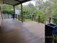 24 Mulga Rd Hawthorndene SA 5051 Delightful timber framed cottage with a wonderful area of front decking. Set on a moderately sloping 1342m2 allotment on the high side of the road, this two bedroom home will appeal to first home buyers, couples or singles. The home sits centrally on the larger than average allotment and the garden has good basic structure and oodles of potential for someone with a green thumb. The location is very tranquil – well away from main roads but close enough to be able to walk to public transport. Entry to the home is via a very substantial front deck, the majority of which is covered and the focal point for any entertaining. The entry hall has a large recessed area which the current vendor used as a study nook. The rooms are all good size with floor boards throughout. The lounge/dining room enjoys the ambiance of a slow combustion heater and there is plenty of timber available to be harvested on the allotment. There are two good size bedrooms the master with built in robes. The kitchen is an inviting space; brightly decorated and with a dishwasher and plenty of cupboards and bench space. The centrally located bathroom has had a partial upgrade with a new toilet and vanity. Overall the home presents honestly with no glaring maintenance issues but oozing with potential and begging for someone to put their own personality on it. A double iron garage at the front has had a basic partial conversion to an insulated music/band room. There is also a garden shed at the rear. A quick settlement is available on this home.