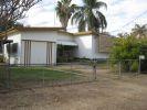  20 KITCHENER ST CLERMONT, QLD 4721 Gosh remember back in the days of She-Ra and He-Man!! With their swords of protection and power, they were indestructible.  Reminds me somewhat of this house...indestructible...as solid as a rock!!  And not just solidly built either, but a solid layout...three large bedrooms, all with built ins and all along the eastern side of the house.  There is a lockable garage at the front along the western side of the house, and alongside this is an additional carport.  An awesome entry porch with access to the garage, and lockable storage units invites you into the home.  The open plan living & dining areas are in the centre of the house, and are huge, with built in shelving and shadow features.  In addition there is the well equipped kitchen with a servery opening onto the dining area.  From the dining area, head down a few stairs to the entertaining area.  Behind the kitchen is a large storage cupboard and laundry with a ramp down to the clothes line.  