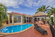 6 Crestmore Court Mermaid Waters Qld 4218 TRANQUIL WIDE WATER VISTA, QUIET AND SERENE POSITION Look
 no further, this quality built home is located in the prestige 
'Paradise Quays' area of Mermaid Waters and is ready to be SOLD! 
Motivated sellers are priced to sell their lovely waterfront lifestyle 
home. This contemporary light filled home showcases 9 foot high 
ceilings, glass windows and sliding doors that cover the entire length 
of the home taking in the sweeping water views. With its relaxed resort 
style feel you will enjoy the benefits of various options to entertain 
from your indoor enclosed sunroom to the outdoor thatched pavilion 
overlooking the sparking in ground pool. Zoned ducted air 
conditioning features throughout the living spaces and good size 
bedrooms, the master bedroom has a generous walk in robe, modern ensuite
 and inviting oval spa. The property sits on a large 821m2 block, has 21
 metres of deep water frontage for any size boat, ocean access and solid
 concrete revetment wall around the bay. This character filled home should certainly be on your list to inspect! Features: • 3 good size bedrooms plus Office or 4th bedroom • 2 bathrooms + powder room • 3 Car lock up garage • Lounge room, dining room and living off kitchen • Water view Kitchen, 2 pac cabinets, granite worktops & s.s appliances • Ducted air-conditioning • Impressive Atrium foyer • Entertaining hardwood timber deck • Solar System • Low maintenance gardens AUCTION ON SITE SATURDAY 9TH AUGUST, 2014 AT 11.00 AM 