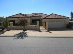  4 Wexford Meander Landsdale WA 6065. Have you been dreaming about living in style in a custom designed split 
level home, Well this home is for you, 4 Double bedrooms all with built 
in robes, master bedroom with spa plus study (this room could be used as
 another bedroom) 3 bathrooms, 4 wc's, ducted air conditioning, ducted 
vaccum cleaning system, huge games room, theatre room, huge granite chef
 kitchen, beautiful alfresco area with below ground pool, timber 
flooring throughout the house and much more. 