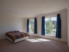  Bermagui   NSW   2546 A high quality 3 bedroom ensuite home with great street appeal, plus additional boat/caravan garaging. A sunny and spacious open plan design features a split level living space at one end, that adds interest and variety to the design. At the other end sits the kitchen with stainless steel oven and ceramic cooktop, and access to a paved rear patio. The living space and front verandah enjoys northerly views over the surrounding area with ocean glimpses in the distance. As well as a double garage with internal access to the house, there is a detached metal garage with extra high clearance especially for boats or caravans. 