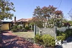 18 Mill Avenue FOREST HILL VIC 3131 Graced by a beautifully manicured rose garden and sitting pretty beyond a picturesque picket fence, this gorgeous single-level home strikes the perfect balance between a classic warm ambience and modern comfort. Wonderfully appointed for peaceful living, stunning timber floors and a pretty leadlight entry permeate a refined formal lounge and dining domain (open-fireplace) capturing tranquil garden vistas while a pristine Stone skylit kitchen with adjoining open plan living/meals area (slow combustion wood heater) serves in style. Three robed bedrooms, including a main bedroom with walk-in robe and ensuite are complemented by a bright central bathroom, ducted heating, evaporative cooling, video intercom, alarm, garden irrigation, covered outdoor pergola for all-season entertaining enveloped by lush fruit trees and double garage plus carport. Located in a quiet, family-friendly locale providing immediate access to Forest Hill chase, bus services Forest Hill Secondary, Parkmore Primary and Emmaus College.  
