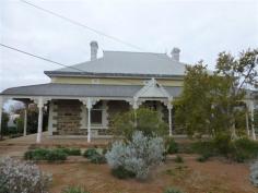  11 West Terrace Orroroo SA 5431 This classic return verandah villa is situated in an ideal residential location and offers 3 spacious bedrooms all featuring ornate fireplaces. There is a magnificent arched hallway with front stained glass windows plus the home still has its original doors and skirtings adding to lovely retained character of the home. Beautiful ornate ceilings are also featured throughout the home. There is a formal dining room with ornate fireplace plus a huge lounge/family room also featuring an open fire place and reverse cycle air conditioning. The kitchen with casual dining area offers ample space and storage plus a reverse cycle air conditioner. The home has two bathroom areas with the main bathroom featuring a separate shower and claw foot bath. A separate inside toilet and large laundry area completes the inside of the home. Outside includes the return bull nose verandah, approx. 1500 gallons of rainwater storage, stone garage and storage shed which along with the home are all set on a large level allotment with the original stone fencing along the front boundary. Inspection of this home is highly recommended.  