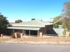 79 Marks St Broken Hill NSW 2880 The Kids Cross The Road To School Situated on a corner allotment at the top of Marks Street this family home has a lot to offer. This solid brick home has a large lounge room, great size study, 3 large bedrooms, built in robe in the master bedroom, hall way, spacious kitchen with pantry and breakfast bar, dining room, bathroom/ laundry and ducted evaporative cooling throughout the home. Outside is a large verandah with a BBQ area, work shed with power attached to the car garage, large 4 car carport with rear access and a rainwater tank. This is a great location with the Central Primary School located directly at the back of this property.   Property Snapshot Property Type: House Construction: Double Brick Land Area: 1,010 m2 Features: Aircooling - Ducted Evaporativ Alarms - Smoke Alarms Carport Ceiling Fans Close to Schools Close To Shops Close to Transport Corner Allotment Dining Room Floor Coverings - Mixed Floors - Carpeted Garage - Single HWS - Electric Lounge Pantry Rainwater Tank Rear Access Robes - Built-In Robes Study/Office Toilet - Located In Bathroom Verandah - at back Verandah - at Front Yard - Fenced