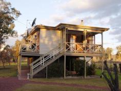 28594 New England Highway STANTHORPE Qld 4380 Set on an acre block at Ballandean, this very neat little property features a highset three bedroom cottage, a separate studio building, great sheds, outdoor entertaining areas, a vege garden and chook pen, 7 water tanks, plus an extensive history to the buildings.  Tyrone Cottage was originally a school house which has been well maintained structurally and is now a very comfortable home. The bedrooms are all of a good size. The kitchen has a large walk in pantry and European appliances including a large gas stove plus separate electric oven. The bathroom is newly renovated, as is the large combined dining/living area. With verandas on three sides of the cottage plus an alfresco gazebo area downstairs, entertaining is a pleasure, and there's even an outside toilet for convenience.  Originally a railway cottage the studio is currently used as a music room and guest quarters, but could also be an art gallery, potters studio, or even a teenagers retreat. The possibilities are even there for a B & B (s.c.a).  With a single lock-up garage and carport beside the house, a large two bay plus workshop colourbond shed to the rear and a large concreted area under the house, storage and car accommodation is well catered for too. There is also a stable/storage shed with original old bullnose awning and concrete floor. Ideal for wood storage, the mower or even a pony or two.  This property has so much to offer and the possibilities are endless. The block beside the property is also for sale so expansion is an option too. Contact Sally Rowen today to arrange an inspection. 