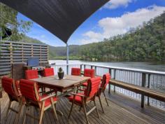 Lot 21 Calabash Bay Berowra Waters 2082 EXCLUSIVE CALABASH BAY Substantial multi-level brick home, perfect condition, in idyllic North-facing ‘private’ bay Fish from the huge mostly covered entertainer’s deck across front of house Modern black & white kitchen, dishwasher, pantry, casual eating area – overlooks river Tiled formal dining room, opens through bi-fold doors to deck Upstairs to carpeted spacious lounge, with fireplace, opens to another deck across front Main bedroom with b/ins , adjoins large bathroom with spa bath. Second bathroom on lower level. Up spiral staircase to large study/office/perhaps bedroom?, then through to dual-level bedroom, with separate toilet Large sunny deck across back, extensive sandstone terracing with established fruit trees and garden, separate laundry/workshop Solid ramp and pontoon, only a short boat ride to secure Residents’ marina and carpark Air-conditioned, fans, solar panels, secret indoor sandstone garden, sunny position, views, and not a cent to spend. 