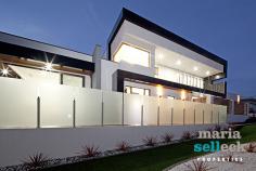  14 Fereday Street, Weston ACT 2611 Emanating a luxurious resort-style ambiance, this masterpiece of substantial proportions has been finished to exacting standards with emphasis on open-plan family living, natural light, space and the exquisite views, making it a rare offering of truly indulgent living. The impressive foyer opens to reveal an inspired design incorporating multiple living spaces, all featuring an extensive use of glass, striking high ceilings and seamless extensions into multiple outdoor living areas. At the heart of the home, the immaculate gourmet kitchen, boasting stone waterfall benches, walk-in-pantry and the finest appliances, overlooks spacious open-plan formal and informal living areas, including a rumpus and study. The rear of the home comprises three large bedrooms, all with built-in-robes and external access to outdoor living spaces, superb spa bathroom with two-way access, separate laundry and double garage with generous storage. Extending from the impressive wood staircase, the private second storey offers the master bedroom with expansive parent's retreat, walk-in-robe, stunning ensuite and balcony with inspiring sunset views.  Other features include ducted heating and cooling, alarm system, video intercom, low maintenance landscaped gardens, outdoor kitchen, eight-person spa, and other luxurious appointments. Located in one of Western Creek's most desirable locations amongst other high-quality homes, this stunning and light-filled residence of approximately 290sqm of living space incorporates an array of designer finishes and a seamless outdoor flow to ensure a lifestyle of privacy, prestige and effortless entertaining in a highly sought-after location. 