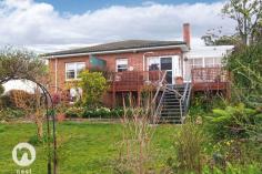  128 Channel Hwy Taroona TAS 7053 This versatile home has a large lounge/dining room with sundeck off, as well as a sun room or children's playroom. There are three bedrooms, and the hallway with polished floor has a meals area. The kitchen was fitted in the nineties, as was the bathroom. There is a generous laundry opening off a side entry which could all be incorporated into a much larger kitchen if ever required. Under the house is a useful storage area. The deck looks to the water and has a sliding door from the main living area. The spacious garden is ideal for children to play and is sunny and safe. Only a short walk from here to the school, soccer ground or beach. 