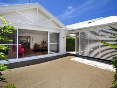 48 Pacific Ave Sunshine Beach QLD 4567  This beautifully presented single level brick home offers a fuss free living, just a few minutes easy stroll to the village and beachfront. What a perfect option for holidaymakers looking for a beach escape so close to the beach. A slatted wall roofed garage sits alongside a security gate in the walled entry courtyard and the home opens up through a wall of glass sliders lining a large living room. This flow through effect is accentuated by a down lit peaked ceiling and the satin sheen of stunning timber flooring. There is access past a trimmed hedgerow at the rear of the garage through to the main entry and vibrant red panels in the boundary fence are softened by grey pavers and ever green Murraya. With the carport acting as a breezeway you can double your entertaining area. A second living area connects through to a well appointed sit up servery kitchen with laminate bench tops, double Smeg wall mounted ovens and electric cook top. There is a window Servery to a fixed roof patio with plenty of room for the outdoor setting. A central hallway feeds to a diagonally set bedroom and a full bathroom. The main ensuited bedroom has sliding door connection to the covered entertaining area. The north east facing rear grounds are a tropical delight. Soaring above an understorey of Golden Cane and Philodendron, a magnificent eight metre high Bismarkia Nobilis Palm shades a gravel pathway to a corner garden shed. The neutral colour scheme, gorgeous timber floors and flow through living rooms, visually expand this single level beachside home. There is room enough for a pool in the side gardens if you like to splash around at home. Pacific Avenue has witnessed a spate of new builds over the last few years and the general consensus of opinion seems to indicate future upgrading and street landscaping. With summer around the corner and the open beaches looking their seasonal best, now is the time to join the beach set. 