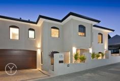  22A Livingstone Street Beaconsfield WA 6162 With views across the rooftops of Fremantle to the Indian Ocean and Garden Island, this near new two storey family home has been designed for entertaining and family fun just minutes from the vibrant heart of South Fremantle. Well appointed and immaculately presented on an elevated easy care block, this home represents sophisticated yet laid back family living with a casual indoor, outdoor lifestyle in mind. Accessed via a quiet rear lane way this private and secure home with double car garage and plenty of storage is set over two levels.  The first floor is open and light offering an open plan kitchen, living and dining with a spectacular view across the Indian Ocean and Garden Island. With Rose Gum timber floors, high ceilings and plenty of natural light, it is about relaxed family living with the stunning Western Australian coastline as its natural back drop. A spacious modern kitchen with pale Caesar Stone bench tops, crisp white cabinetry and stainless steel Bosch appliances, enjoys a picturesque outlook opening onto a spacious private deck with valley and ocean views. The upper level floor plan also incorporates an equipped theatre room with dividing doors and tiered leather seating leading off the main living space, for fabulous movie nights or watching the footy finals! A spectacular master suite with the same knockout views is the ultimate parents' retreat with its adjoining tiled terrace and ultra modern ensuite, with double vanity set into stone bench tops and an expansive double shower. The lower level floor plan incorporates a study and three generously sized bedrooms, all with built-in robes, and a contemporary second bathroom with Caesar Stone bench tops, a bath with spa jets and floor to ceiling neutral tiling. A large under stair built in storage area is the perfect place to keep your favourite wine and books. Designed for entertaining, the alfresco living area is perfect for family gatherings, with its undercover outdoor kitchen, barbecue area and wood fired pizza oven.  An L shaped, heated pool with water feature, swim and spa jets, tucked behind glass fencing, makes it an easy space to welcome family and friends in an informal outdoor setting. Sitting just moments from the centre of South Fremantle's bustling cafe strip, a short walk to Beaconsfield Primary and within easy reach of parks, beaches and transport, this near new, impeccably presented, low maintenance home offers up ideal family living in a quiet and secure setting. 4 BED, PLUS STUDY, 2.5 BATHS 2 CAR 