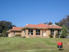  Bermagui   NSW   2546 A high quality 3 bedroom ensuite home with great street appeal, plus additional boat/caravan garaging. A sunny and spacious open plan design features a split level living space at one end, that adds interest and variety to the design. At the other end sits the kitchen with stainless steel oven and ceramic cooktop, and access to a paved rear patio. The living space and front verandah enjoys northerly views over the surrounding area with ocean glimpses in the distance. As well as a double garage with internal access to the house, there is a detached metal garage with extra high clearance especially for boats or caravans. 