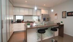  8-10 Kambah Place Reedy Creek Qld 4227 Relax and entertain with family and friends in the 9 metre salt water pool with attractive water feature and outdoor shower while enjoying complete privacy Impress all with the Italian floor tiles throughout and Italian bench tops in the note worthy German Craft kitchen with additional plumbed fridge included and glass feature screen The Spotted gum floors literally light up the whole entrance and formal living area while the sandstone on the patios enhance the beauty of a the quiet serene setting The main bedroom offers amazing storage and wonderful ensuite with spa with exceptional furnishings and mesmerising wall paper rarely seen in Australian homes 
