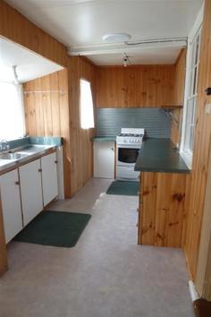  5 Bonney Street Deloraine TAS 7304 2 bedroom home with optional third bedroom or study Wood heating Galley kitchen Sunroom Shower over bath Private secluded backyard Lock up garage 