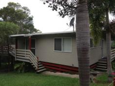  22 Ashton Street Macleay Island Qld 4184 Situated in a quiet Street this lovely home is kept private from the road with established large shrubs at the front of the property.  It is fully fenced with 6 ft fences at the back of the lovely yard that has beautiful massive palms among the gardens.  Enjoy summer with your fenced swimming pool and barbecue on the huge decks on the side and back of the home. Downstairs is perfect if you wish to work from home, with an office set up in one of the rooms and another room free as a 3rd bedroom. The two bedrooms upstairs have fans and wall heaters as well as built in wardrobes.  The home has raked high ceilings for an extra feeling of space. There is a bathtub and separate toilet, and the kitchen is modern and spacious.  There is air conditioning in the main living area which has screen doors out on to the deck.  There is also a double carport and garden sheds. A lovely home, close to the jetty and shops.  The vendor would love to rent back the home after sale, so you have a built in tenant if you want one. 