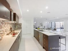 46 Dell Rd St Lucia QLD 4067 A truly superlative locale that is quiet and leafy, yet is within 200m 
of the University of Queensland, brings a central advantage to this 
newly completed contemporary residence. Built over two meticulously 
finished levels, the well designed home incorporates open plan living, 
alfresco spaces and a relaxed liveability that is well suited to a low 
maintenance lifestyle. 
 
Indoors and out, neutral finishes bring timeless appeal, while quality 
fittings and fixtures, including Caesarstone bench tops and timber 
veneer cabinetry all contribute to the polished, sophisticated feel. 
Additionally, a judicious use of both translucent glass and high-set 
windows ensures maximum light and natural airflow throughout the home, 
without compromising privacy. 
 
Surrounded by space for living and dining, the streamlined kitchen makes
 a strong style statement in the main living area, with rich mocha 
tones, stainless steel appliances, plentiful cabinetry and a walk-in 
pantry. Stacking doors allows for easy integration with the outdoor 
living room, while the adjacent media zone brings a separate space for 
more sedentary pursuits. 
 
Upstairs, four large bedrooms all have integrated wardrobes, with the 
main suite making use of a walk-in wardrobe and a spacious ensuite 
complete with dual, above-counter basins and a separate toilet. There is
 a secondary living space on this upper level - ideal for children or as
 a casual lounge, while a powder room, study, air-conditioning and dual 
car garage completes the detailed offering. Outside, the easy-care yard 
brings a secluded space to relax, with tidy gardens, a patch of green 
lawn and a timber sundeck for lazing about. 
