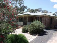 237B Northern Road  ROMA QLD 4455 Situated on 5 acres, in a very secluded area is this beautiful brick veneer home. A formal entry at the front leads to the elegant lounge room with huge lead lighting windows. The open plan living takes in the family and dining areas plus the spacious Tassie Oak kitchen boasting pantry, microwave box, appliance hideaway and big island bench. There is no shortage of space with 4 ample B/I bedrooms (ensuite in main) plus office, separate shower with Spa bath, fully screened rear verandah, ducted air conditioning and 2 way wood heater. 9m x 6m LU powered plus air conditioned garage with extra 6 metre extension, 2 bay carport , bird & dog cages, green house & established gardens with own gazebo. 