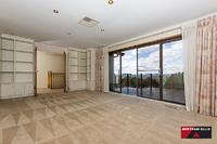  30 Winstanley Street Chapman ACT 2611 This large five bedroom, three bathroom home is located at the top of Chapman on a 1387m block with panoramic views over Canberra! The front deck is ready for the next gathering of family or friends to enjoy the vistas from this elevated vantage point. The home boasts many endearing features that a family home owner will appreciate, including; as new designer kitchen with top grade appliances, large laundry, plenty of cupboard space, two ensuites plus a renovated bathroom with in-slab heating. The list doesn't stop here though, halfway down the stairs there is a secret door to the children's craft room that even Professor Dumbledore would approve of. A home office and rumpus room are located on the ground floor along with plenty of extra storage space and internal access to the double garage with remote controlled doors. The landscaped rear garden is home to the cubby house to beat all cubby houses, including a fort, fireman's pole and sway bridge! A second garage is located to the side of the home with plumbing in place for an ensuite if desired. An easy care garden has a mix of smaller shrubs, larger shade trees and two very healthy orange trees. The orientation of the home captures the winter sunshine beautifully and in the middle of winter when the fog has set in, the odds are that you will be floating above it sharing the sunlight with Black Mountain as your new neighbour. Surrounded by homes worth well over the one million dollar mark, buyers are sure to find value on offer. • Ducted gas heating • Evaporative cooling • Rinnai instant gas hot water • Large deck with amazing view • Three bathrooms • Home office plus rumpus • Internal access from garage • Circular driveway • Landscaped gardens • Cubby house • Additional double garage 