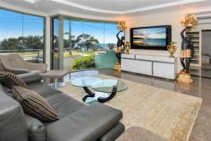 2 Denning St South Coogee NSW 2034 Prime position, opposite parklands and never to be built out ocean and coastline views. 
 
Nothing has been spared in this quality built home that oozes class and 
style, from the granite floors to the Waterford crystal chandeliers. 
 
Spanning over three levels, this home was built for the large family with entertaining in mind. 
 
Entry level, with granite tiles throughout the casual and dining areas with direct access to large balcony and amazing views. 
 
Formal and informal living areas, fabulous kitchen, granite bench tops, integrated fridge and loads of storage. 
 
Top level consists of 4 spacious bedrooms, all with built-in robes. 
 
The main bedroom (parents wing) with retreat area, full sized bathroom with spa and double basins and pear wood robes. 
 
A second bathroom accommodates the remaining three bedrooms, laundry shute and walk in linen cupboard. 
 
Lower level, triple garaging, fully tiled, bathroom, sauna and leafy garden complete with pizza oven. 