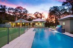  9 Warrandyte Court Camp Mountain QLD 4520 Position is a key feature that differentiates this property from others in the Samford district and indeed acreage properties in Brisbane generally. Only 7 mins to Ferny Grove train station means transit to the city centre and events is easy and quick. Driving time is only 30 minutes to the city. Uniquely situated at the base of Camp Mountain, bordering the D'Aguilar National Park, with nature trails right at your doorstep, lies this hidden gem on 3.75 acres. Privacy is paramount and the new owners will enjoy a chilled and relaxed lifestyle with the assets that abound.  A recent extension by Garth Chapman Queenslanders has created a large 6.8 x 6.5m outdoor pavilion. Such a beautiful space, it has everything you need for entertaining in style built in seating, BBQ with stone bench tops, storage areas and tv points, ready for your widescreen TV. Take 2 steps down from the pavilion and you are in your massive, granite paved sparkling pool area with semi frameless glass fencing, hot water outdoor shower, beautiful water feature and a pump room that is impressive in itself, allowing convenient storage for chemicals, pool toys etc. This will be a place you will be very proud to entertain from.  Adjacent to the pavilion area is the kitchen has had a recent update whilst retaining its farmhouse kitchen styling, with stone bench tops, step in pantry and quality 900mm Smeg freestanding oven and gas cooktop. Large windows open out to a servery, and are conveniently positioned to make entertaining a pleasure.  This majestic north facing Queenslander has 15 foot vented timber ceilings and careful window and silky oak French doors to the wide verandahs. This home is very cool during the summer months and with the use of the ceiling fans has no need of air conditioning.  The family room features a brick open fireplace, ensuring many winter months enjoyed by the warmth of the fireside. The bedroom wing has of 4 bedrooms, 3 of which have new built in wardrobes with custom shelving. These all open out to a rumpus area with floor to ceiling sliding doors which open up to allow further breezes to flow through. The master bedroom is spacious and features a large walk in robe and ensuite with sunken spa bath and sash windows that can be opened up to enjoy the views while soaking the day away.  Downstairs, a recently built 6m x 6m office is perfect for those who work from home with its separate entrance, but could be used as a teenage retreat or media room perhaps? The owner has taken advantage of the lands natural drainage, which allows water to flow to the dam with pumps for irrigation to the gardens and a total of 80,000 litres of water storage ensures you should never run dry. 