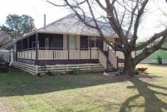 Solid 3 Bedroom Timber Home  3    1   Located in the peaceful town of Allora is this fantastic timber home that would make for the perfect renovator. It was built to last with hardwood timber floors throughout that would polish up very nicely and behind all the wall sheeting is the original VJ timber walls (the sheeting has been pulled off in the living areas).  The home has also been moved to the site and re-stumped onto steel stumps. Other features are 3 large bedrooms, a spacious open plan living/dining room with a woodfire heater that flows into the kitchen. There is a main bathroom with a shower, bath, toilet and vanity and the laundry is located outside. The home also has 12ft ceilings throughout and a deck on 2 sides and it's more than comfortable enough to live in while you carry out some renovations. This home has strong bones and plenty of original features and is only a short walk from the town center. It's well worth an inspection for anyone looking for their next project. Come and see what you can make of this solid Queenslander. 