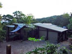  17 Marsh Pl Currumbin Valley QLD 4223 Once in a while a home comes up for sale that demands your full and undivided attention. This home is located in the picturesque setting of Currumbin Valley only 14 minutes to the M1 Freeway, 20 minutes to Coolangatta Airport and 22 mins to Tweed Heads.  Currumbin Valley is located on the Southern end of the Gold Coast, SE Queensland is a very sought after area as it does not have a suburban feel but more a relaxed lifestyle that people only dream about. Very rarely do people have the opportunity to seize a dual living home like this as they do not come up for sale very often. This 1,000 sq. metre Timber Mansion is certainly not your average house with a full story to tell. One main feature of this home is the vast size it has to offer. With plenty of room on each level there is plenty of room for 2 families to live in with complete freedom and privacy from each other, ideal also for the extended family, or those kids who don’t want to leave home! Using recycled timbers from places like the Brisbane and Sydney Wharves, not only do you know this is a solid home but imagine the stories around the dinner table while entertaining guests. It is a testament to history, rising 15m up from the ground. Solid hardwood timber floors and custom built hardwood doors throughout accentuate the cathedral ceilings from 10ft to 14ft that make this home unique. A 2kw solar system solar water and 115,000 litre rainwater capacity make this home very eco-friendly and saves on those costly power and water bills. The first level is set out as a large open deck and currently used as a gymnasium / bedroom if needed and can easily be used for storage or as one of the many alfresco areas watching the world go by with birdlife and flora. The second level abounds with features like its own double garage, open plan living areas, laundry, vac-maid system for easy cleaning, a large bathroom and 2 king-size bedrooms (one with walk-in wardrobe and loft) with views through the trees.The main bedroom has its own private 64sq m deck and a private-tree-walk to clothes line. This is also ideal for the extended family as this area is completely separate from the upper level.  The Third level is an entertainer's delight and needs to be seen to be truly appreciated, with a huge open plan living areas which all lead out onto large full length decks to invite the outdoors in. There are 3 bedrooms with a large family bathroom and separate guest powder room, Laundry, vac-maid system. The master bedroom has its own private deck, large bathroom and huge walk-in wardrobe and its own private detached deck used for feeding local birds accessed by a raised boardwalk. This level is flat throughout with the feeling of living high in the trees, totally unique in anyone’s eyes. The home is set on 5892 m2 and gently encompasses the hill on which it is built on, and is built with the landscape in mind which ensures there is no worry for slippage or other concerns and takes full advantage of the wide valley views offered by its position. Also being at the end of the cul-de-sac on a private road, you could feel as if you were in a quiet peaceful world of your own, relaxing with the sound of the various parrots or other wildlife that abounds in the area but still only a short 9klms to Currumbin and Palm Beach. This home is perfect for the person who needs to be close to everything but still wants to be at one with nature. This mansion is a once in a lifetime opportunity with the owner being the licensed builder and using the timber collected over many years that will never be available again. With a replacement cost of over $3.7million and built with irreplaceable hardwood this house is a regrettable sale and is a give-away price for anyone who appreciates good quality workmanship.  The owner’s plans are set and a sale is needed. For your guided inspection through this stately residence contact us today. Afternoon inspections would be the best time to appreciate all this home has to offer. Features »    Owners keen to move »    Inspection an absolute must »    Offers prior to auction date considered »    Loads of room for the extended family »    A very rare find 