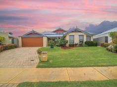  12 Kalinda Pass Piara Waters WA 6112 You will be impressed with this lovely 4 bedroom and 2 bathroom home on big block with all the following features: * Spacious kitchen with dishwasher, ample cupboards and walk-in-pantry * Open plan family and meals with TV points and gas bayonet * Separate games area with Foxtel connection leading out to covered patio with Cafe Blinds * Formal lounge with TV point and roller shutter blinds * Main bedroom with roller shutter blinds, his and hers walk in robes, en-suite with corner bath and separate toilet * Minor bedrooms carpeted - all double rooms with BIR * Double garage, with auto door and shoppers entrance. Other extra's include: Roller Shutter Blinds Evaporative Air Conditioner Solar Panels Alarm Auto reticulation to landscaped garden Block 633m2 Great location, close to parks, schools and bus routes. Private viewings available. 