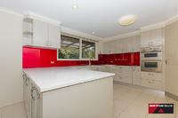  30 Winstanley Street Chapman ACT 2611 This large five bedroom, three bathroom home is located at the top of Chapman on a 1387m block with panoramic views over Canberra! The front deck is ready for the next gathering of family or friends to enjoy the vistas from this elevated vantage point. The home boasts many endearing features that a family home owner will appreciate, including; as new designer kitchen with top grade appliances, large laundry, plenty of cupboard space, two ensuites plus a renovated bathroom with in-slab heating. The list doesn't stop here though, halfway down the stairs there is a secret door to the children's craft room that even Professor Dumbledore would approve of. A home office and rumpus room are located on the ground floor along with plenty of extra storage space and internal access to the double garage with remote controlled doors. The landscaped rear garden is home to the cubby house to beat all cubby houses, including a fort, fireman's pole and sway bridge! A second garage is located to the side of the home with plumbing in place for an ensuite if desired. An easy care garden has a mix of smaller shrubs, larger shade trees and two very healthy orange trees. The orientation of the home captures the winter sunshine beautifully and in the middle of winter when the fog has set in, the odds are that you will be floating above it sharing the sunlight with Black Mountain as your new neighbour. Surrounded by homes worth well over the one million dollar mark, buyers are sure to find value on offer. • Ducted gas heating • Evaporative cooling • Rinnai instant gas hot water • Large deck with amazing view • Three bathrooms • Home office plus rumpus • Internal access from garage • Circular driveway • Landscaped gardens • Cubby house • Additional double garage 