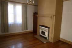  5 Bonney Street Deloraine TAS 7304 2 bedroom home with optional third bedroom or study Wood heating Galley kitchen Sunroom Shower over bath Private secluded backyard Lock up garage 
