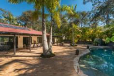 6 Nyrang Dr Pimpama QLD 4209 DRIVE INTO YOUR WORLD
				 PRICE REDUCED - DON'T MISS THIS OPPORTUNITY! 
					TRANQUILLY PLUS MAN CAVE!! 
 
Looking for a private hideaway? Then don't miss out on this rare 
opportunity to secure a property of this size with this much space in 
the absolute perfect location! 
 
Situated on a massive 5936m2 block this home has to been seen to be 
appreciated, offering everything you could need for a relaxed country 
feel yet so close to the urban hustle. From the gardens to the pool, 
entertaining areas and large livings spaces, this property has so much 
to offer. If you're seeking a change of pace, need that extra space or 
just enjoy your privacy then this property is a must to inspect! 
 
THE HOME: 
 
3 Bedrooms all with built in robes and ceiling fans 
Large study with its own entry 
Main bedroom is of good size and features a walk in robe and dressing 
area, an ensuite bathroom with large corner spa, a split system air 
conditioning unit and glass sliding door that leads out to the tropical 
gardens 
2nd bedroom has its own entry leading out to the tranquil gardens 
There are 2 large living and dining rooms both formal and informal 
Spacious home-style kitchen with walk in pantry includes dishwasher and views out to the pool 
Laundry with plenty of storage space 
Full covered bull nose verandas surround the home 
Coonara heating for those cooler nights 
Fully tiled throughout and views to the gardens from every room in the house 