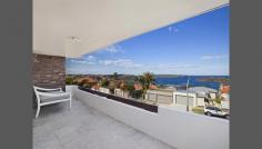  4/33 Moruben Road Mosman NSW 2088 A Beautifully Presented Two Bedroom Home with Fabulous Harbour Views I am thrilled to offer this stunning 105 square metre two bedroom home with wonderful views of the Harbour and beyond to the Heads within this small tightly held development in one the most sought after streets in Mosman. From the minute you walk through the front door you will appreciate that all of the hard work has been done for you, all you need to do is move in.  It comprises a bright and airy living room with timber floating floor, your focus is immediately drawn to the floor to ceiling sliding glazed doors that beautifully frame the sweeping views across Middle Harbour and beyond to the Heads. The living space has the perfect mix of indoor and outdoor living which integrates a sizeable balcony ideal for entertaining guests. The kitchen is fresh with clean lines and comes with plenty of storage space, there are two spacious bedrooms, generous shower room and separate laundry. Furthermore the apartment comes with fitted blinds and custom made plantation shutters that add the finishing touches which will make this apartment a highly desirable acquisition.  There is also one large 22 square metre secure garage space on title. The location is excellent within close proximity to the shops and amenities on offer at Mosman village. 